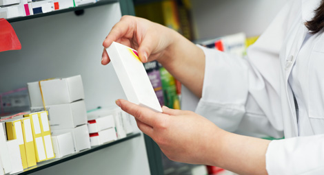A pharmacist looking at some tablets